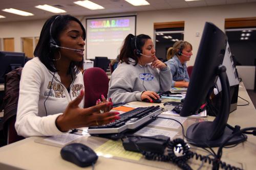Tonisha Daniel, left, sophomore in LAS; Melissa Montoya, center, junior in LAS; and Kaitlin Nolan, sophomore in Business, speak with alumni over the phone about donations Nov. 6. Erica Magda

