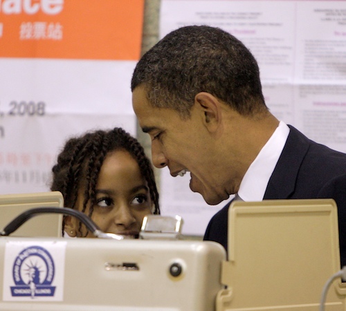 Democratic presidential candidate Sen. Barack Obama, D-Ill. talks to his daughter Malia as he casts his votes at a polling place in Chicago, Tuesday, Nov. 4, 2008. Jae C. Hong, The Associated Press
