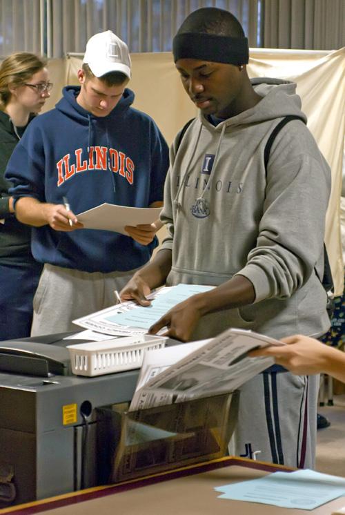 Brendon Tero, sophomore in LAS, turns in his completed ballot at the Snyder Residence Hall polling place in Champaign, Ill., early Nov. 4. Erica Magda
