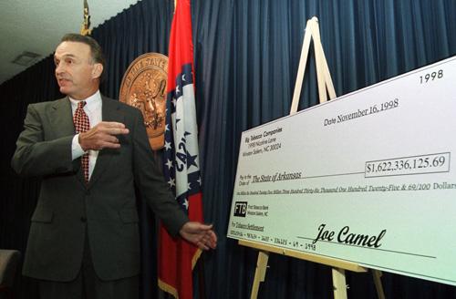 Ark. Attorney General Winston Bryant speaks in Little Rock, Ark., in front of a mock check for $1.6 billion from the tobacco industry on Nov. 16, 1998. Golden LEAF has diversified its grant beneficiaries. Mike Wintroath, The Associated Press
