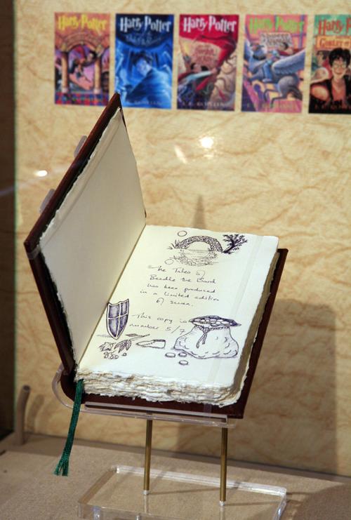 In this image released by Scholastic, one of only seven original copies of The Tales of Beedle the Bard, created, handwritten and illustrated by J.K. Rowling, is unveiled, Wednesday, Dec. 3, 2008, at the New York Public Library. Diane Bondareff, The Associated Press

