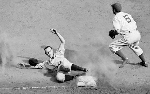 In this Oct. 4, 1941 file photo, Joe Gordon, Yankees second baseman, slams into third base to complete a triple in the fifth inning of the third World Series at Ebbets Field in New York. Gordon is now in the Hall of Fame. The Associated Press File Photo
