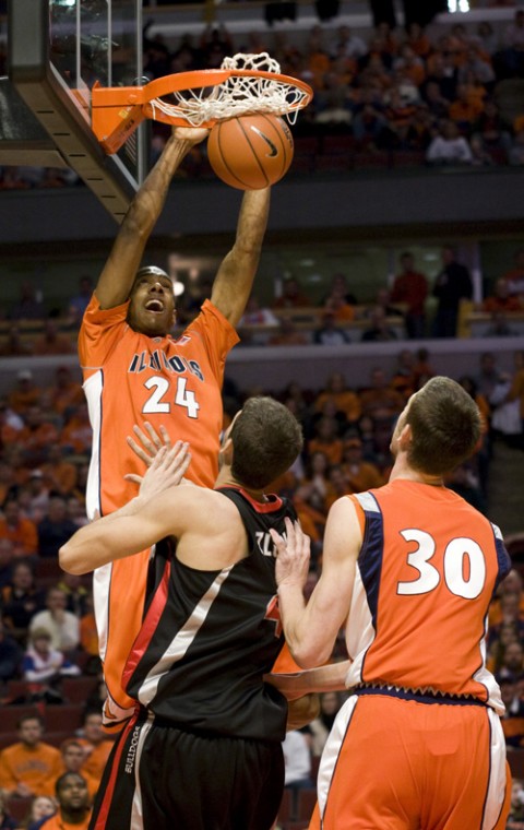 Mike Davis executes an alley-oop at the basketball game held at the United Center in Chicago against Georgia on Saturday. The Illini defeated the Bulldogs 76-42. Erica Magda
