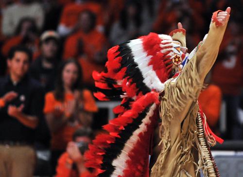 Logan Ponce, portraying Chief Illiniwek, gestures while performing during the Three-In-One at The Next Dance at Assembly Hall on Nov. 15. The University insists it will not reinstate the tradition. Erica Magda
