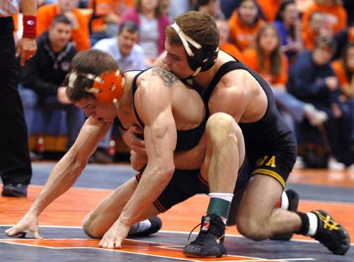 Jimmy Kennedy competes against an Iowa wrestler on Feb. 24 at Huff Hall. Kennedy and the Illini will play top-ranked wrestlers in Las Vegas. Erica Magda
