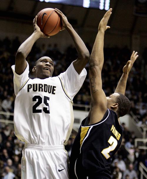 Purdue forward JaJuan Johnson, left, shoots over Iowa center David Palmer in the second half of a game in West Lafayette, Ind., Sunday. Purdue defeated Iowa 75-53. Michael Conroy, The Associated Press

