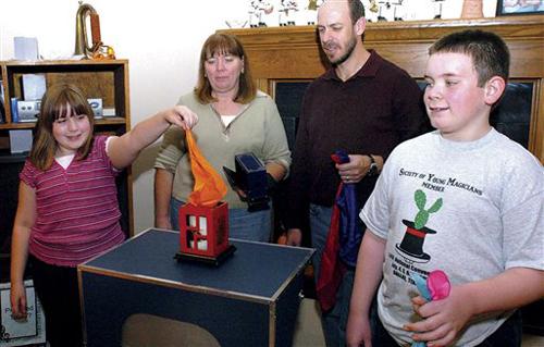 Danville magician Christopher Bontjes, second from right, performs magic with, from left: his daughter Jill, 9, wife Julie, and son John, 11, at their home in Westville, Ill., in a Nov. 6, 2008 photo. Christopher has done magic for 35 years in front of au Matt Huber
