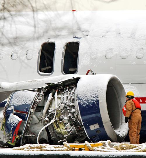 A worker looks into the damaged right engine of the US Airways Airbus A320 that made an emergency landing Thursday in the Hudson River as the plane sits on a barge after being lifted out of the river in New York on Sunday. Kathy Willens, The Associated Press
