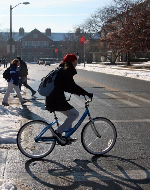 A student rides her bike to class across Goodwin Avenue in Urbana on Jan. 22. The cost for the project has risen to $2.65 million. Erica Magda
