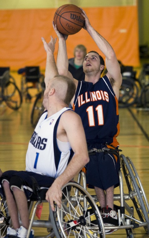 Brad Meyer The Daily Illini Steve Serio shoots the ball while being gaurded by Danny Fik of Dallas during one of the Mens wheelchair basketball game that was held in the ARC on Saturday, Jan. 24, 2009.
