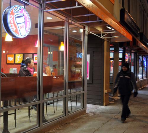 Wesley Fane The Daily Illini Pedestrians walk past Dunkin Donuts on Green Street in Campustown Thursday evening. The restaurant is one of numerous businesses that recently opened or are soon to open in the area.
