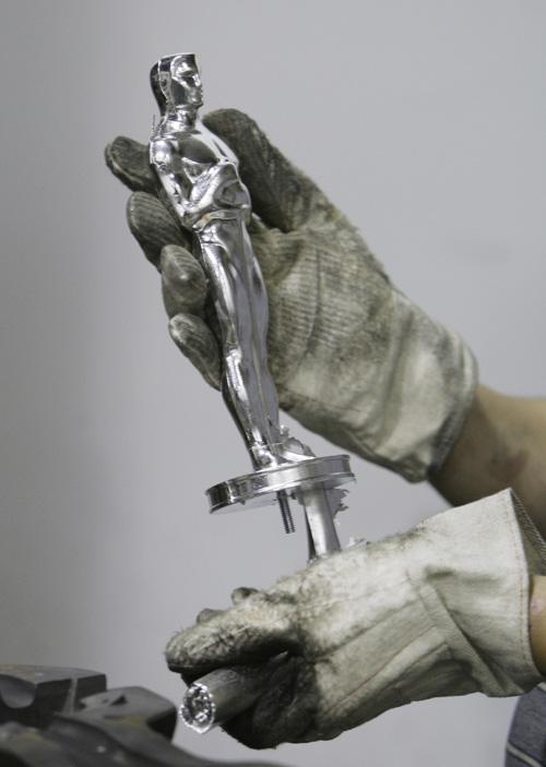 Martin Vega inspects Oscar #3453 after casting at R.S. Owens & Company Thursday, Jan. 22, 2009, in Chicago. M. Spencer Green, The Associated Press
