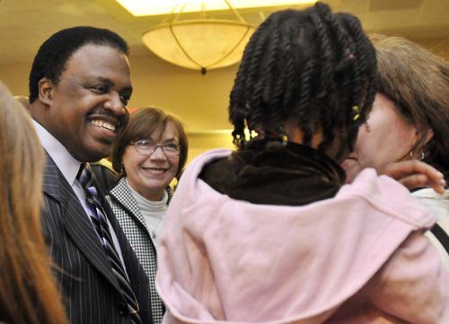 Bishop Kenneth C. Ulmer, left, and State Representative Naomi Jakobsson, center, speak with Imani Weibel, 8, and her mother Sue Feldman after the 2009 Rev. Dr. Martin Luther King Jr. Countywide Celebration on Friday in Champaign. Ulmer, a University gradu Erica Magda
