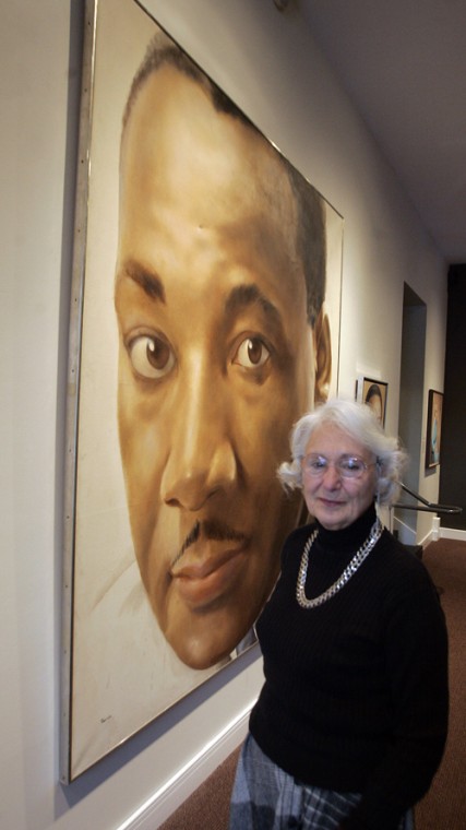 Leonore Templeton poses with a portrait of the Rev. Martin Luther King, Jr. at the Mattatuck Museum in Waterbury, Conn., Thursday, Jan. 15, 2009. Bob Child, The Associated Press
