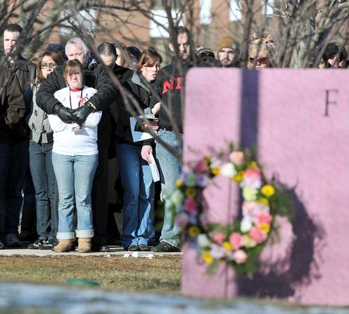 Audience members watch a wreath laying memorial outside Cole Hall on the campus of Northern Illinois University in Dekalb, Ill. on Saturday, Feb. 14, 2009. The ceremony marked to the minute the one year anniversary of the school shooting on the campus, wh Erica Magda
