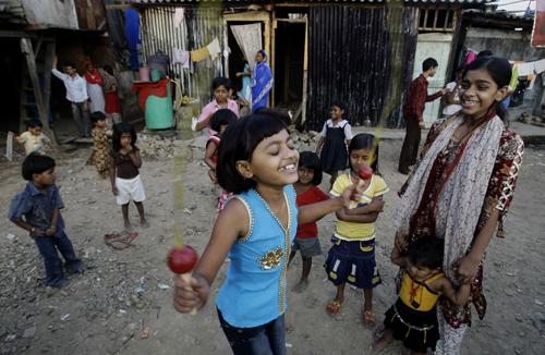 Rubina Ali Qureshi, 9, centre, jumps rope as her friends look on near her home in a slum in Bandra, suburban Mumbai, India, Sunday, Jan. 25, 2009. Gautam Singh, The Associated Press

