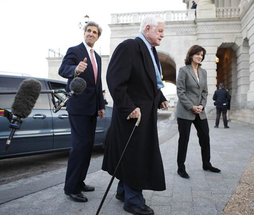 Sen. Edward M. Kennedy, D-Mass., center, and Sen. John Kerry, D-Mass., left, walk away after speaking with media before the stimulus bill vote in Washington on Monday. Lawrence Jackson, The Associated Press
