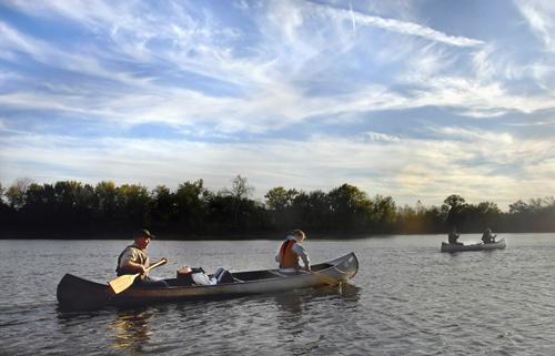 Mark Wertz and his daughters, Alissa and Lauren, paddle toward the setting sun as they re-enter the Illinois River from Sanganois Conservation Area to return to their put-in point in Browning, Ill., on Oct. 19, 2008. David Zalaznik, The Associated Press
