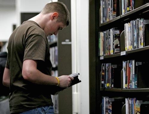 Tyler Crow, junior in Engineering, browses the media stacks in the Undergraduate Library on Sunday. Erica Magda
