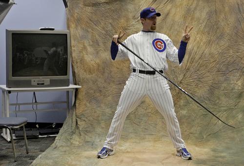 Chicago Cubs Ryan Dempster has some fun as he poses with a hockey stick during the teams picture day at spring training baseball Monday, Feb. 23, 2009, in Mesa, Ariz. (AP Photo/Morry Gash)
