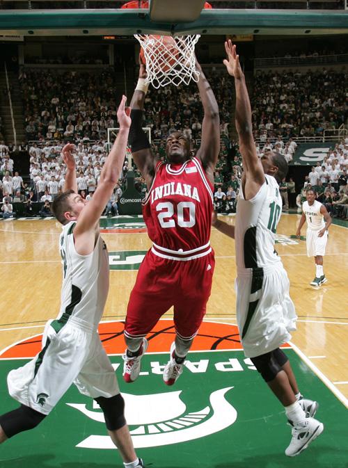 Indianas Nick Williams (20) shoots between Michigan States Goran Suton, left, and Delvon Roe during the first half of an NCAA college basketball game Saturday, Feb. 7, 2009, in East Lansing, Mich. Michigan State won 75-47. (AP Photo/Al Goldis)
