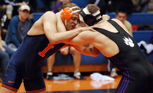 Mike Poeta competes against an Iowa wrestler on Feb. 24 at Huff Hall. The senior led the Illini to a win over Purdue during the weekend. Brennan Caughron
