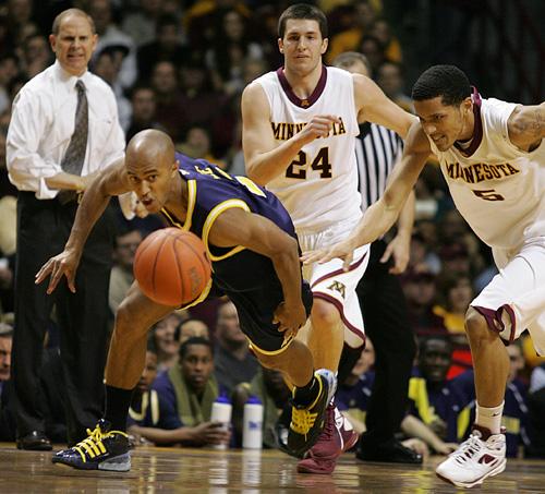 Michigan guard C.J. Lee, left, and Minnesota guard Devoe Joseph race for the ball in Minneapolis on Saturday. The Wolverines and Gophers, who both finished 9-9 in conference, are two of a handful of teams hoping to earn NCAA Tournament invitations. The Associated Press
