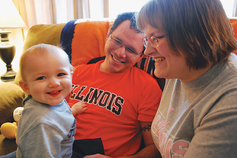 Parents Jason and Rachel Smith, seniors in FAA and LAS respectively, pose for a photo with their daughter Elizabeth at their house in Champaign on Monday, March 16, 2009.

