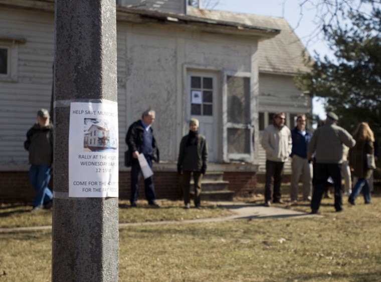 Supporters gather around historic Mumford House on March 4 to protest the University’s plans to relocate the house. The protesters want the University to consider creative uses for the home, which has been in its current location since 1870.
