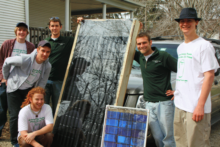 Members of the Green Energy Team pose for a photo with a Solar Energy Heater. The Green Energy Team is making Solar Energy Heaters out of aluminum cans for use by underprivileged families.
