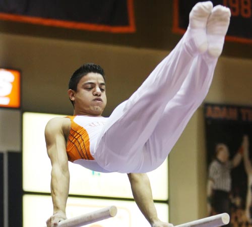 Trevor Greene The Daily Illini Illinois Andres Saavedra competes on the parallel bars during the meet against Iowa in Huff Hall on Saturday, Feb. 28. The Illini defeated the Hawkeyes 353.000 to 337.500.
