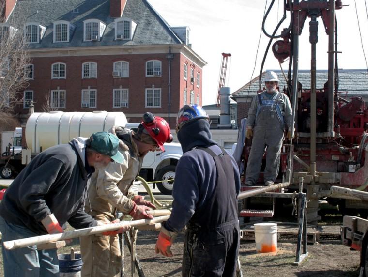 Quaternary geologist Mike Barnhardt, left, drilling assistants Bob Bryant and Rich Padilla, middle, and driller Jack Aud, right, work together to remove an underground core sample behind the Natural Resources Building during the Naturally Illinois Expo on Saturday. From the bedrock, the team extracted glacial deposits that date back as far as 300 million years ago.
