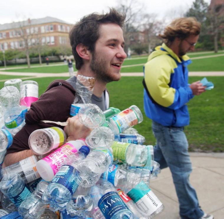 Matt Rundquist, freshman in Natural Resources and Environmental Sciences, runs a lap around the North Quad with all his plastic bottles from one week as a part of the Water Drinking Contest, an Earth Week related event, in Urbana, April 21, 2009. Participants tasted different kinds of water and were quizzed on the flavor. We aim to increase awareness about how destructive drinking out of bottles is, David Duncan, junior in Physics said. People mostly cant tell the difference anyway, so why waste all the resources?
