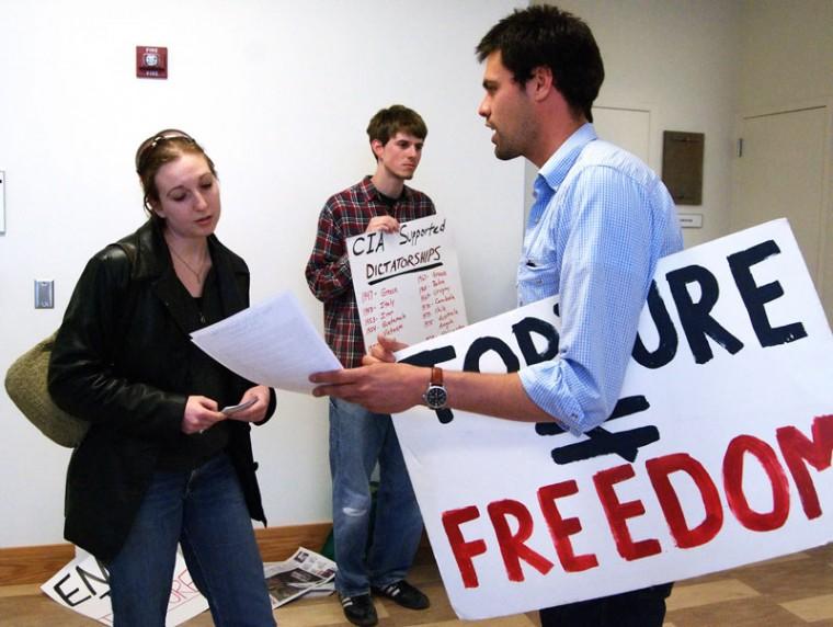 An unidentified student talks with Jacob Crawford, right, senior in LAS and member of Iraq Veterans Against the War, about CIA policies during a protest of a CIA recruiting meeting Thursday, April 9, 2009, at the Business Instructional Facility. The presence of the protesters caused the recruiting meeting to be cancelled due to CIA policy.
