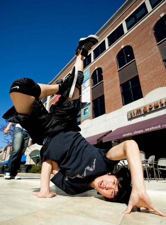 Jacob Lee, junior in LAS and member of Floor Lovers Illinois, break dances at the corner of Neil and Main streets for the Boneyard Arts Festival on Thursday. The Floor Lovers Illinois, along with other performers, participated in the Boneyard Arts Festival.
