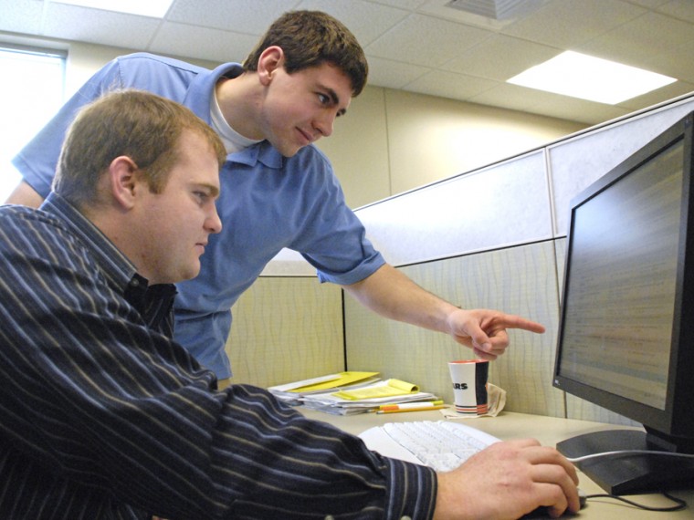 Adam Helton, (sitting) junior in LAS, and Brian Schaefer, senior in LAS, look over a computer monitor at the ADM Sustainable BioEnergy Modeling Center on Tuesday March 17, 2009. Helton and Schaefer are a few of the several University of Illinois interns researching Bio-Fuels.
