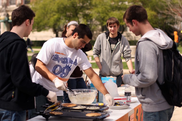Chris Picchietti, middle left, junior in AHS, prepares pancakes for Tommy Stern, left, freshman in Engineering, Mike O’Shea, middle right, freshman in general studies, and Andrew Smiles freshman in Engineering, Thursday.
