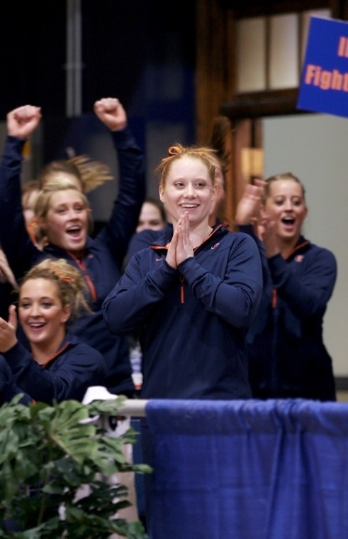 Members of the Illinois Womens gymnastics team cheer as freshman Kelsey Joannides (center) is named the winner in the individual vault at the 2009 Big Ten Tournament on Saturday, March 21st at Huff Hall. Joannides scored a 9.925 on the vault, helping the Illini take second place in the tournament.
