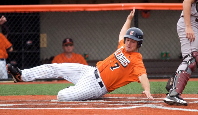 Illinois’ Aaron Johnson slides safely into home during the first game of a doubleheader against Minnesota at Illinois Field on Saturday. The Illini now rank third in the Big Ten behind Ohio State and Indiana.
