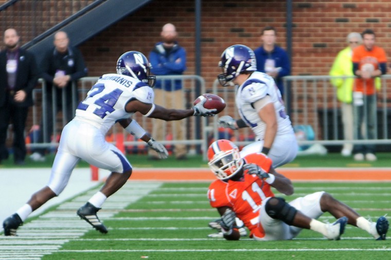 Northwesterns Sherrick McManis (24) runs past Illinois Jarred Fayson (11) with what was later ruled to be an interception in the fourth quarter of the game at Memorial Stadium on Saturday, Nov. 14, 2009. A week after beating Iowa, the Wildcats pounced on Illinois chance at getting a bowl spot, beating the Illini 21-16.
