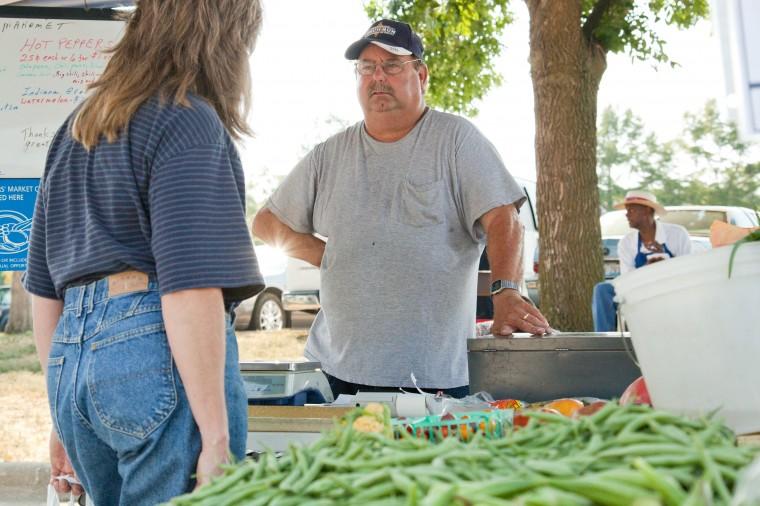 Ed Harper, of Mahomet, talks to a costumer at his stand in the historic First Street Farmers Market on Thursday, Sep. 1, 2011. Harper is excited to be able to sell homemade goods again after an Illinois law-enforced ban on their sale is lifted.
