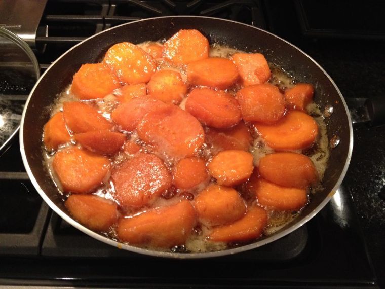 Candied sweet potatoes simmer until their middles are soft. The dish can be served right out of the skillet.