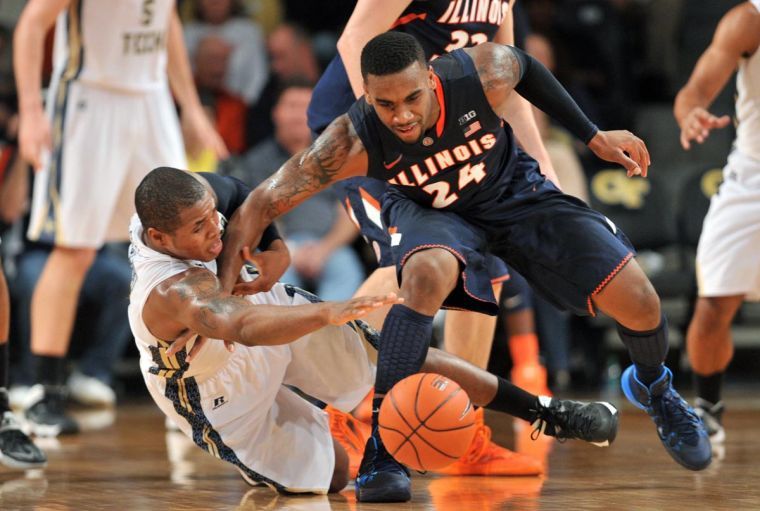 Georgia Tech’s Marcus Georges-Hunt falls to the floor as he fights for a loose ball with Illinois’ Rayvonte Rice in the first half of the Big Ten ACC Challenge game at McCamish Pavilion in Atlanta on Tuesday.