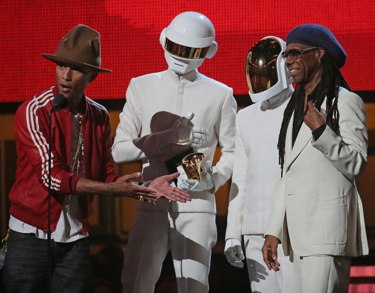 Pharrnell Williams, Daft Punk duo, and Nile Rogers on stage to accept the Grammy for Record of the Year at the 56th Annual Grammy Awards at Staples Center in Los Angeles on Sunday, Jan. 26, 2014.