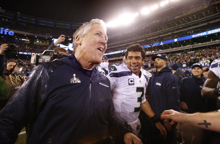 Seattle Seahawks head coach Pete Carroll and quarterback Russell Wilson celebrate after a 43-8 victory against the Denver Broncos in Super Bowl XLVIII at MetLife Stadium in East Rutherford, N.J., on Sunday, Feb. 2, 2014. 