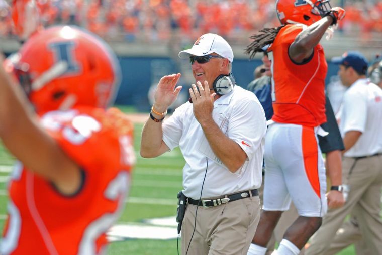 Illini offensive coordinatior Bill Cubit celebrates a touchdown against Cincinnati on Sept. 7. After he turned the unit around, Cubit faces new challenges in his second season.