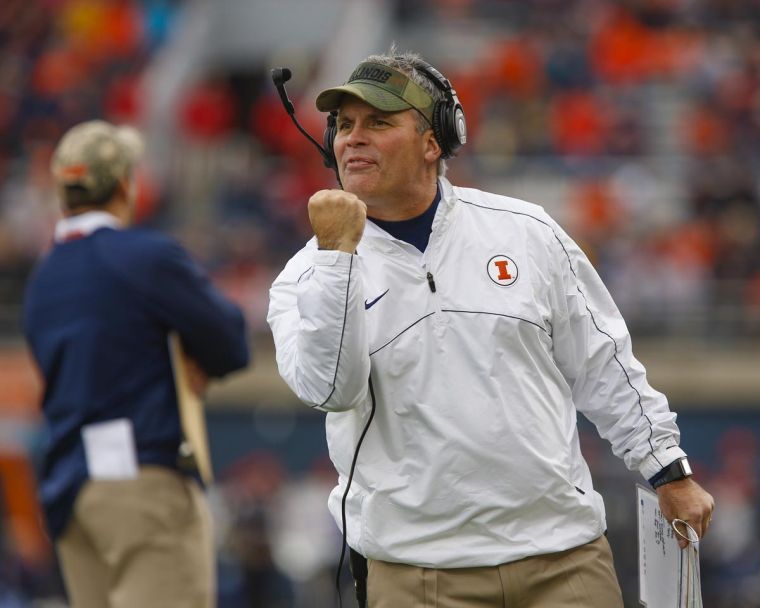 Illinois’ head coach Tim Beckman signals a face mask to a referee during the game against No. 3 Ohio State at Memorial Stadium in Champaign, Ill.. on Nov. 16, 2013. The Illini lost, 60-35. The team looks to fill many roles formerly held by graduating seniors, including quarterback, for the coming season. 