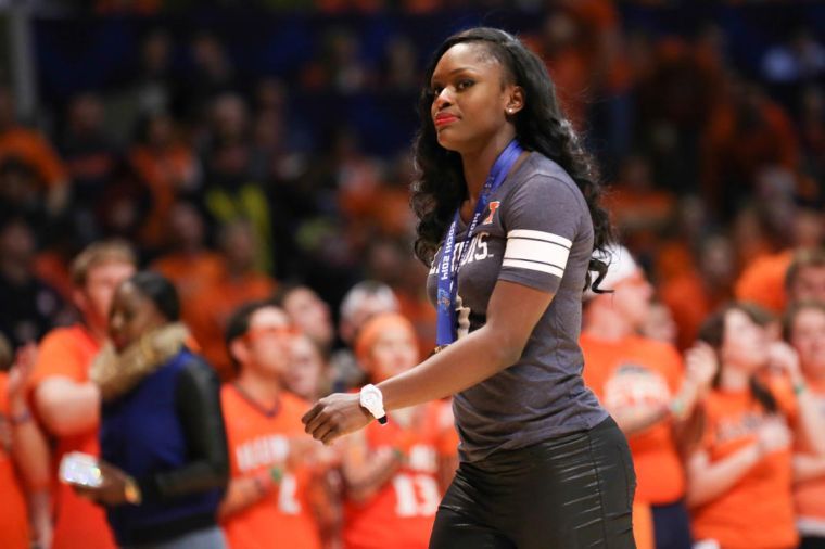 Aja Evans, a bronze medalist at the 2014 Winter Olympics, and former University of Illinois track and field runner, walks off the court at State Farm Center after being recognized during a break at the Michigan-Illinois game.