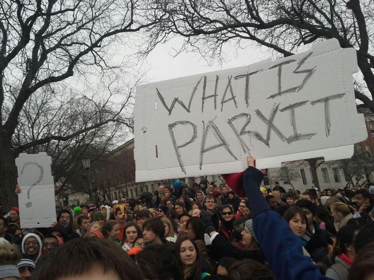 Alumnus Shagun Pradhan, one of the creators of ParXit app, holds a pizza box with the phrase What is Partix among a crowd on the Quad on Monday, Feb. 24. Pradhan visited campus during Ellen DeGeneres social media event to publicize his app.