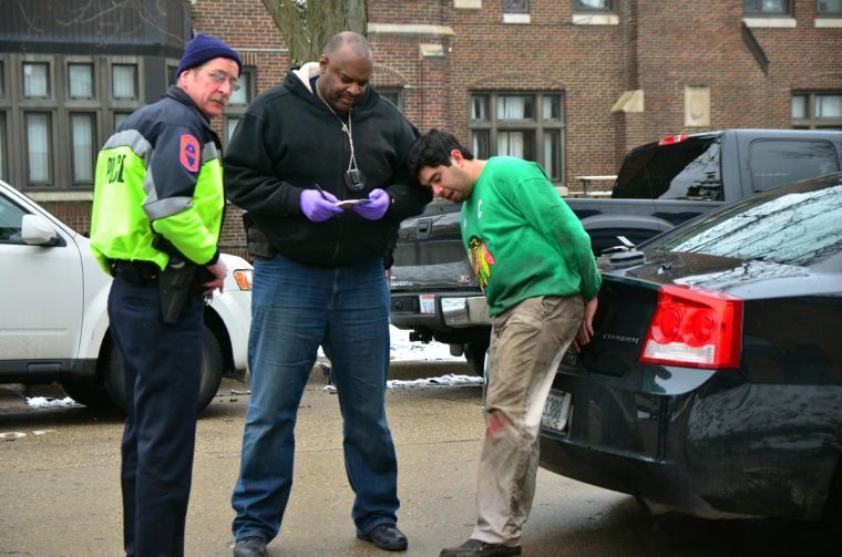 Police officers interview a suspect on the 1100 block of South Second Street, Champaign.